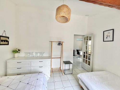 a white bedroom with a bed and a mirror at 3 bedrooms house - garden - Parking, Antony Center near Paris and Orly in Antony