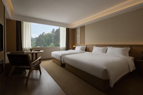Postel nebo postele na pokoji v ubytování Yanyu Yunxi Resort Hotel 烟雨云兮酒店