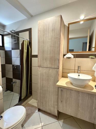 a bathroom with a sink and a toilet and a mirror at EndlessSummer Beach Escape in Coco