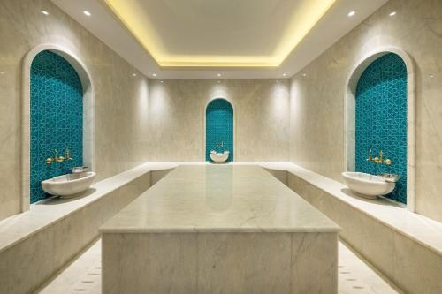 a bathroom with two sinks and two mirrors at Thalassa Beach Resort in Vokolidha