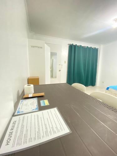 a room with a table with papers on it at La Pearla Place Boracay Dmall in Boracay