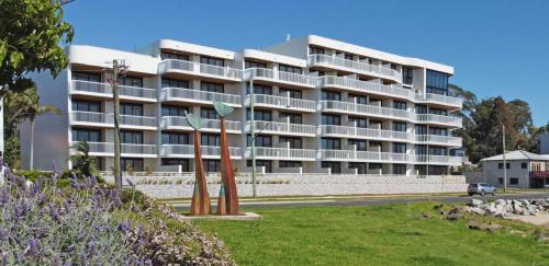 a large white building on the side of a road at Elegant 2-Bed Apartment with Incredible Bay Views in Batemans Bay