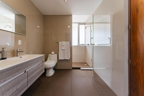 a bathroom with a toilet and a sink and a shower at Antara apartments by VH in Mexico City