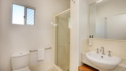 a bathroom with a toilet and a sink and a shower at Best Western Caboolture Gateway Motel in Caboolture