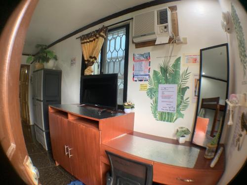 a mirror reflection of a desk in a room at JML homestay in General Luna