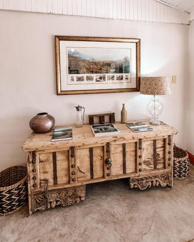 a wooden desk in a room with a mirror at Fugitives Drift Guest House in Rorkeʼs Drift