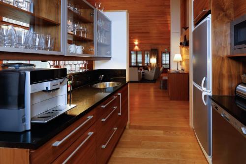a kitchen with a black counter top and a refrigerator at KätkänKiisa in Kittilä