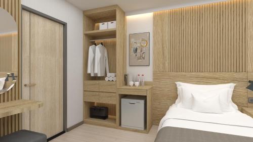 a bedroom with a bed and a closet at Winston Hotel in Bangkok