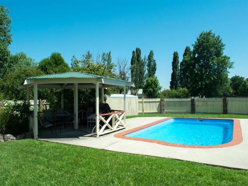 a patio with a gazebo and a swimming pool at Rest Point Motor Inn in Glen Innes