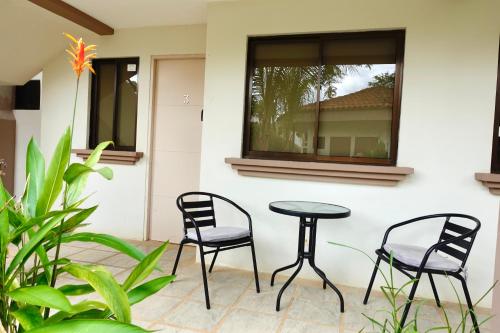two chairs and a table in front of a window at Coco Cabana Ground Floor Condo in Coco
