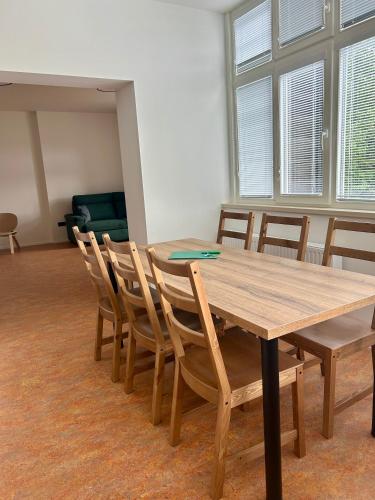 a wooden table and chairs in a room at Vila Silva Karlova Studánka in Karlova Studánka