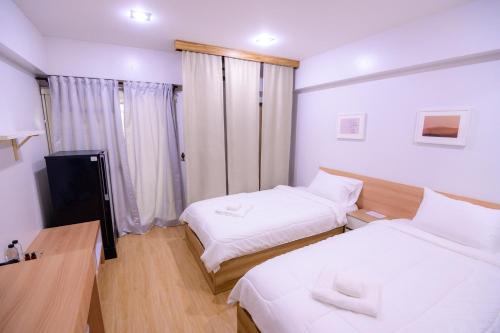 Postel nebo postele na pokoji v ubytování Creston Grand Hotel Suphan Buri