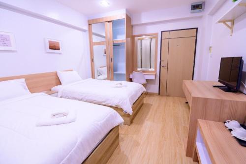 Postel nebo postele na pokoji v ubytování Creston Grand Hotel Suphan Buri