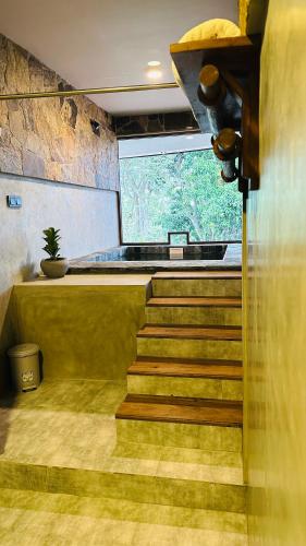 a staircase in a room with a large window at The Symbol of Ella in Ella