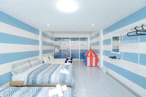 a bedroom with two beds and a play house at Trisisters Home, near Leegarden in Hat Yai
