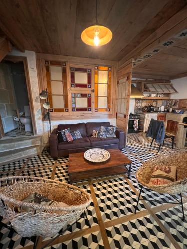 a living room with a couch and two tables at Chez max in Saint-Laurent-dʼAigouze