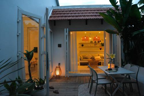 a room with a table and chairs on a patio at Jasmine Garden in Hoi An