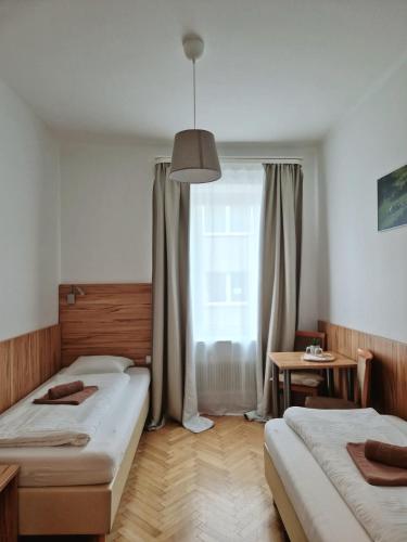 a bedroom with two beds and a window at Pension Jahn in Salzburg