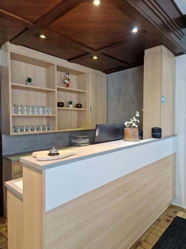 a reception desk with a laptop on top of it at Pension Jahn in Salzburg