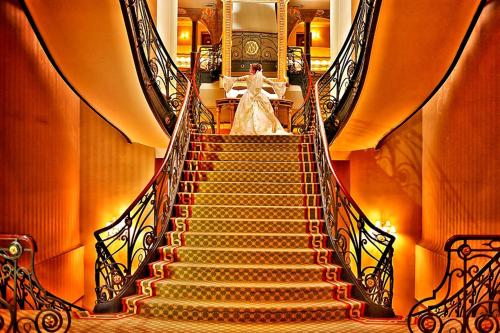 a bride walking down a staircase in a building at Gran Hotel Ciudad de México Zócalo View in Mexico City