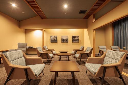 a waiting room with chairs and tables at Sennomori in Ise