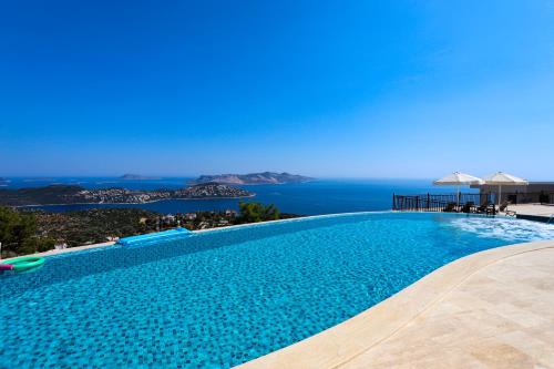 a swimming pool with a view of the ocean at Kaleli Deluxe Homes in Kas