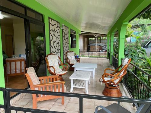 a patio with chairs and a table on a building at Ohana in Papetoai