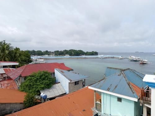 a view of a river with houses and a dock at Drage Tourist Inn in Logon