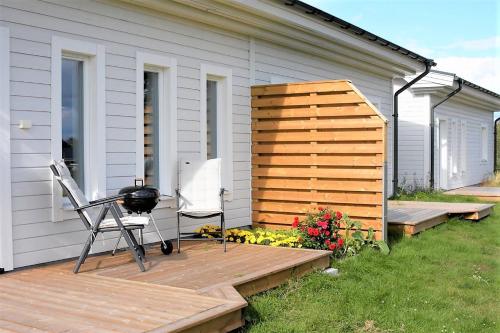 a grill on a wooden deck next to a house at Pajala Centralt 19B in Pajala