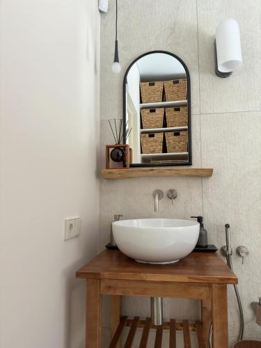 a bathroom with a white sink and a mirror at IVIS House Lakeside Retreat in Vilnius in Vilnius