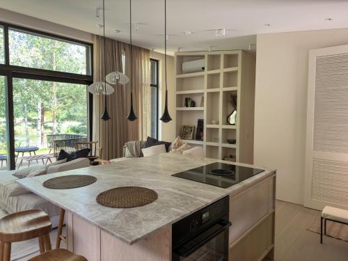 a kitchen with a large island in a room at IVIS House Lakeside Retreat in Vilnius in Vilnius