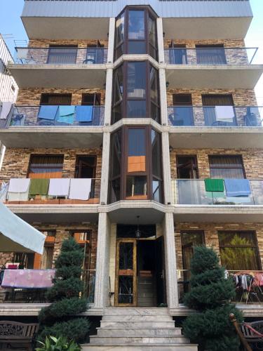 an apartment building with stairs in front of it at hotel twins G&G in K'obulet'i