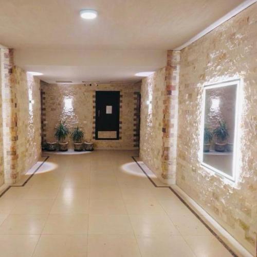 an empty hallway with plants on the walls of a building at Chalet at Grand Hills Village - ONLY For Family in El Hamam