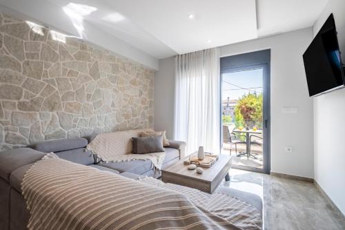 a living room with a bed and a couch at Orion Luxury Apartments in Nafplio