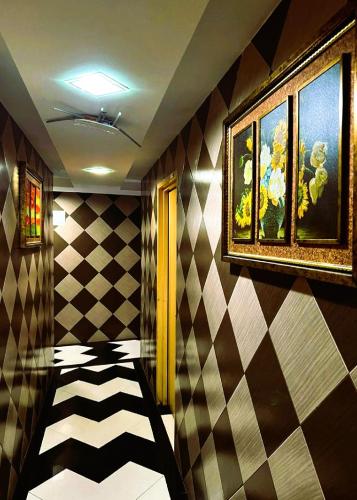 a room with a checkered floor and a room with a painting at Bukit Beruntung Hotel in Rawang