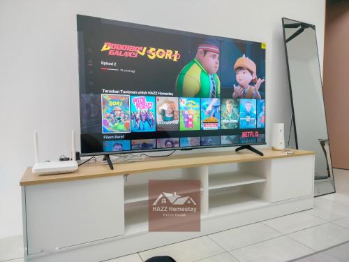 a large flat screen tv sitting on top of a table at HAZZ Homestay Puncak Ihsan in Kulim