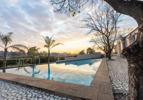 a swimming pool in the backyard of a house at ANEW Hotel & Convention Centre OR Tambo Johannesburg in Benoni