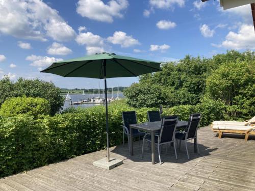 a table with chairs and an umbrella on a patio at Kieholm in Bohnert