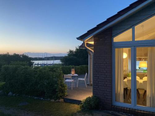 a house with a deck with a table and chairs at Kieholm in Bohnert