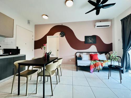 a living room with a bed and a table and chairs at New The Sun Homestay at Sg Nibong nearby Queensbay or PISA or FTZ Bayan Lepas HENG in Bayan Lepas