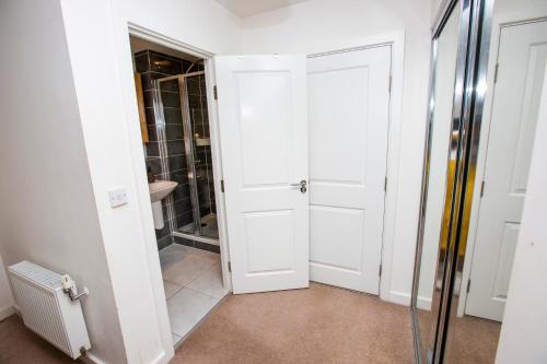 a bathroom with a shower and a glass door at Waterfront- London Greenwich o2 Arena 2 Bed Flat in London