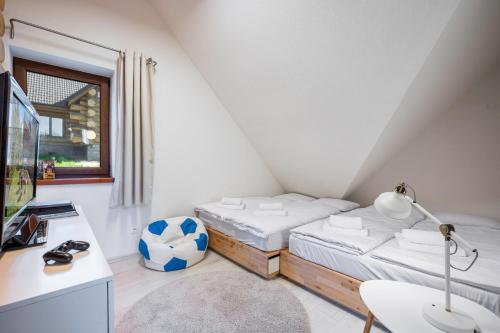 a bedroom with a bed and a desk with a soccer ball at Chalet Piros Tale - Sauna - Jacuzzi - Beautiful scenery - Kids playground - In the forest in Tale