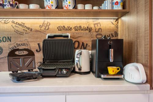 a kitchen counter with appliances sitting on a shelf at Chalet Piros Tale - Sauna - Jacuzzi - Beautiful scenery - Kids playground - In the forest in Tale