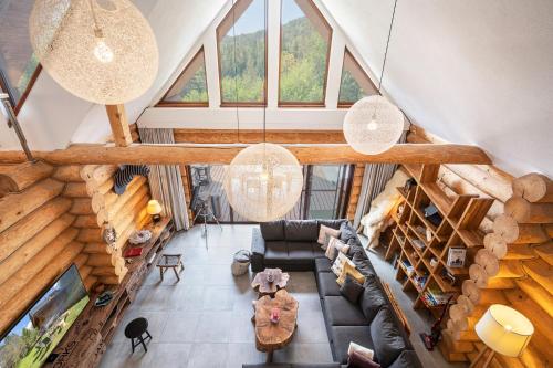 an overhead view of a living room with wooden ceilings at Chalet Piros Tale - Sauna - Jacuzzi - Beautiful scenery - Kids playground - In the forest in Tale