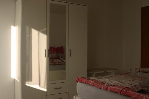 a bedroom with a bed and a dresser at ApartmentBuyMetzingen in Riederich