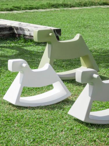 two white benches sitting on the grass at Sunlight On the Peninsula in Eluan