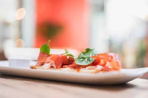 a plate of food sitting on a table at Hotel San Juan de los Reyes in Toledo