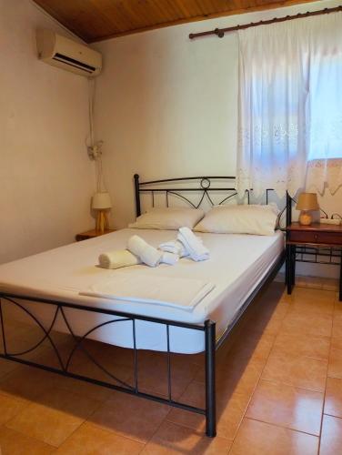 a bed with two pillows on it in a room at Amaryllis sweet home in Pyrgos