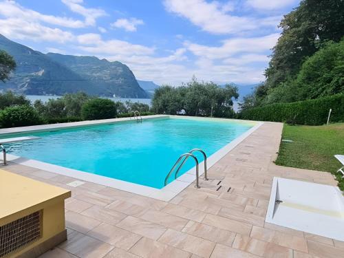 a swimming pool with a view of the mountains at Casa PG - Appartamento Vista Lago in Monte Isola