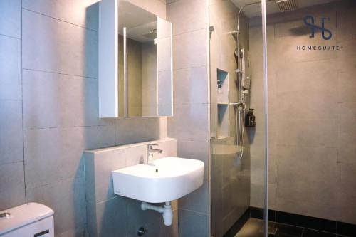 a bathroom with a sink and a shower at Homesuite' Home at Jesselton Quay in Kota Kinabalu
